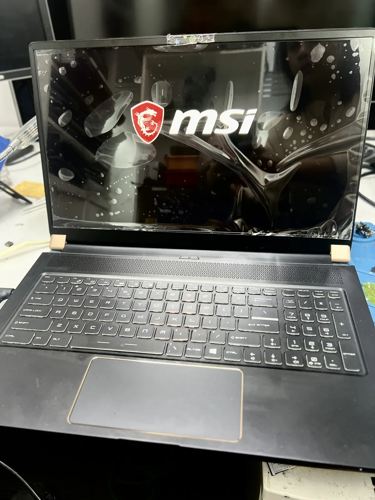 Laptop with the display panel clamped during screen replacement