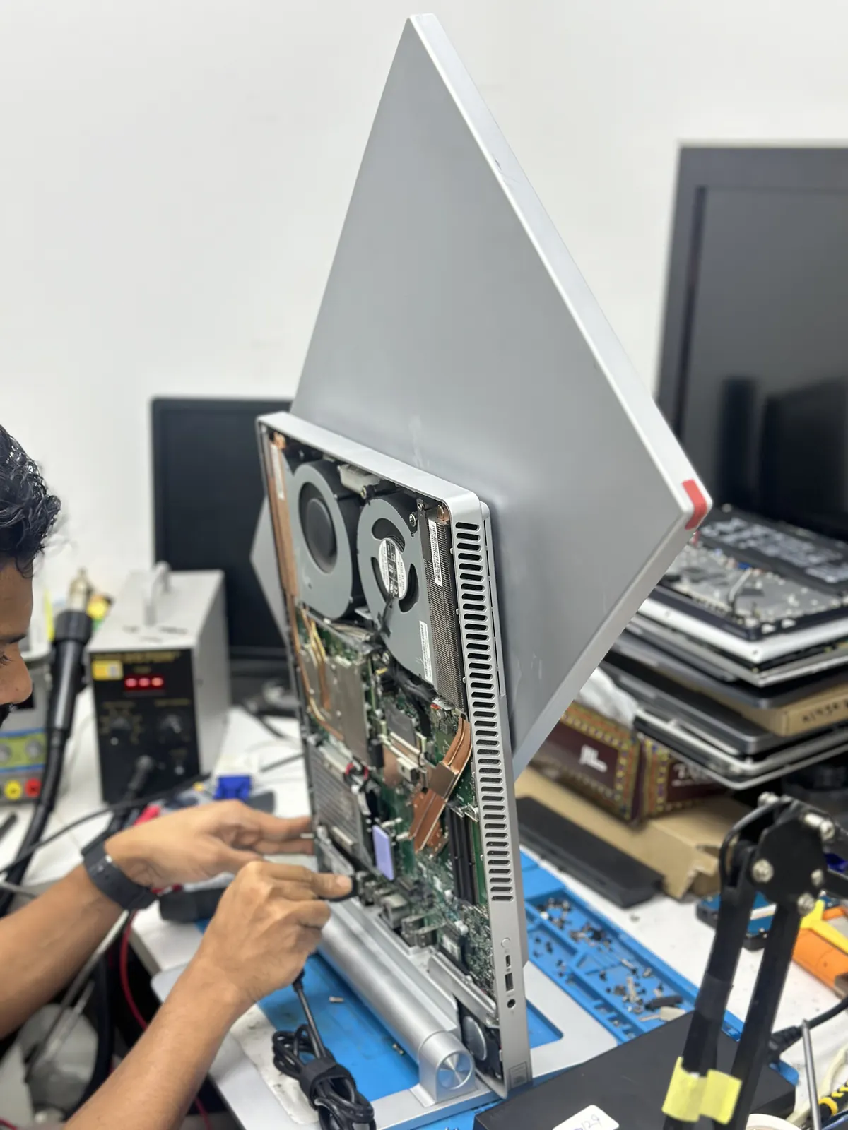 iMac being serviced with precision tools
