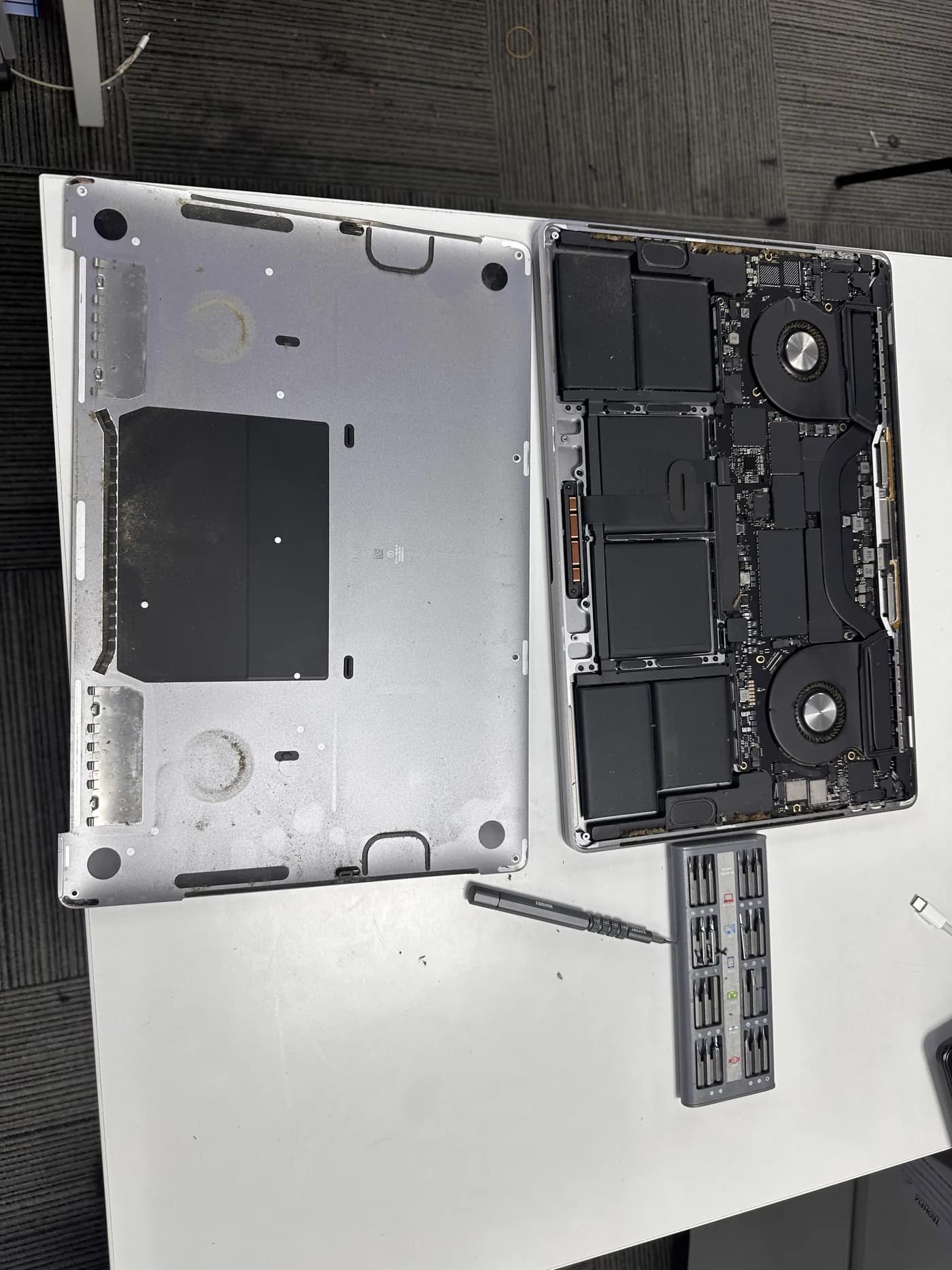 MacBook Pro opened on the bench showing internal components